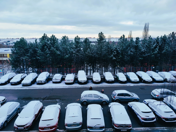 snow covered cars and the valley beyond